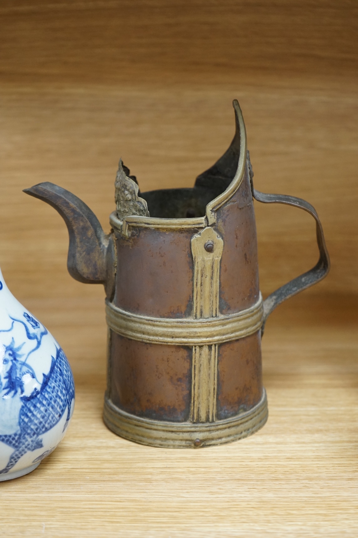A Chinese blue and white bottle vase, a crackle glaze vase and a Tibetan copper and brass ‘monk’ cap’ ewer (3), tallest 21cm